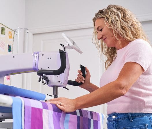 A quilter guiding the Super Sixteen by its handles
